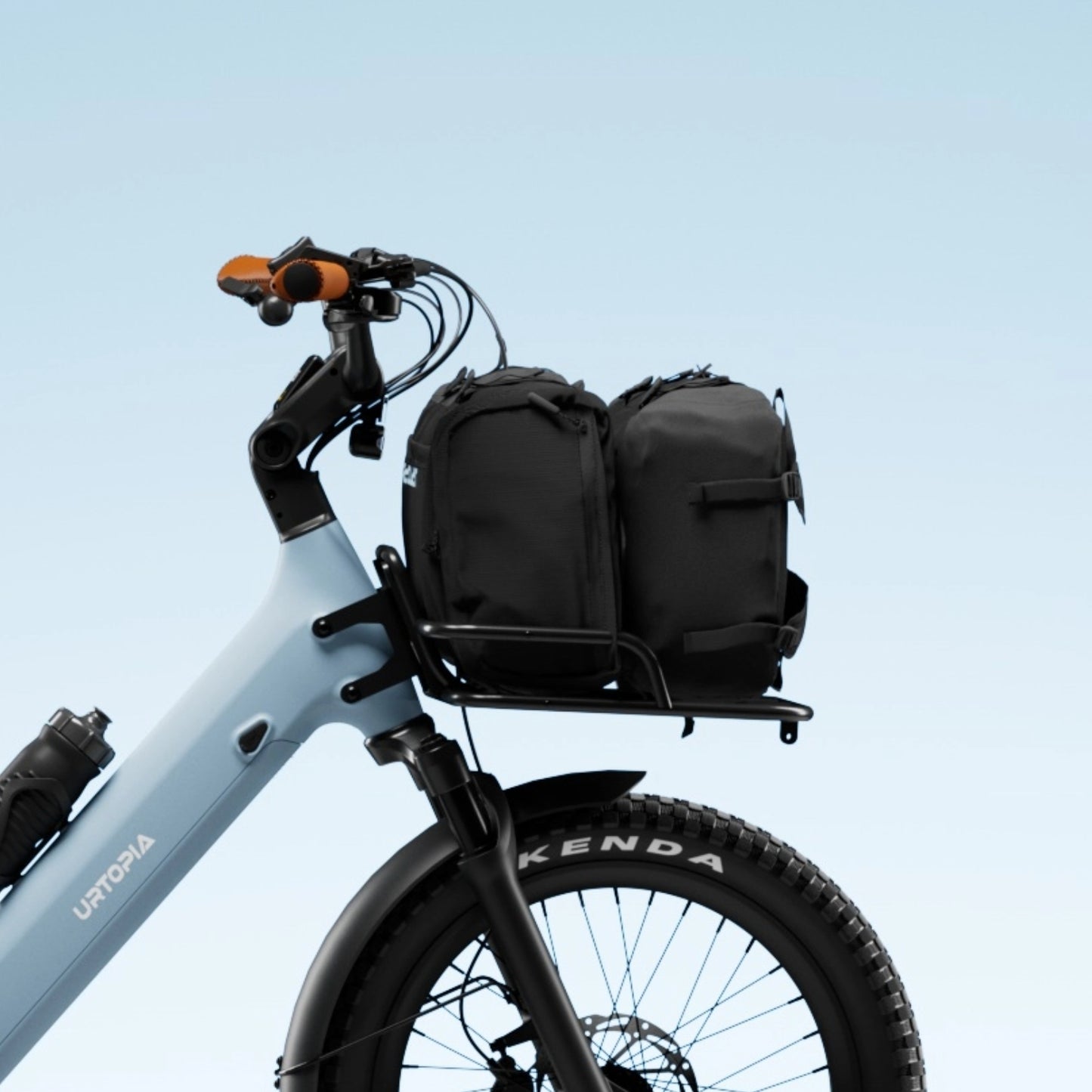 Black front cargo rack on an e-bike, loaded with two black bags, demonstrating its utility for commuting.