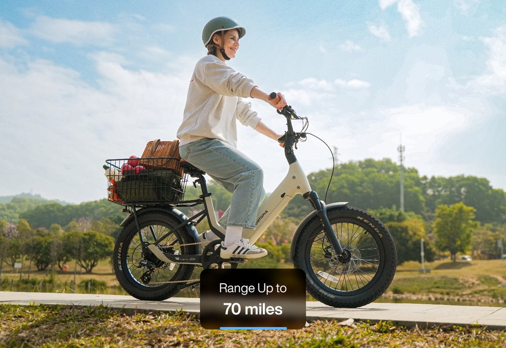 A person riding a Lightweight Fat Tire eBike with a basket of items, showcasing a range of up to 70 miles.