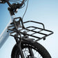 Black front cargo rack mounted on a light blue e-bike, model Joy Carbon.